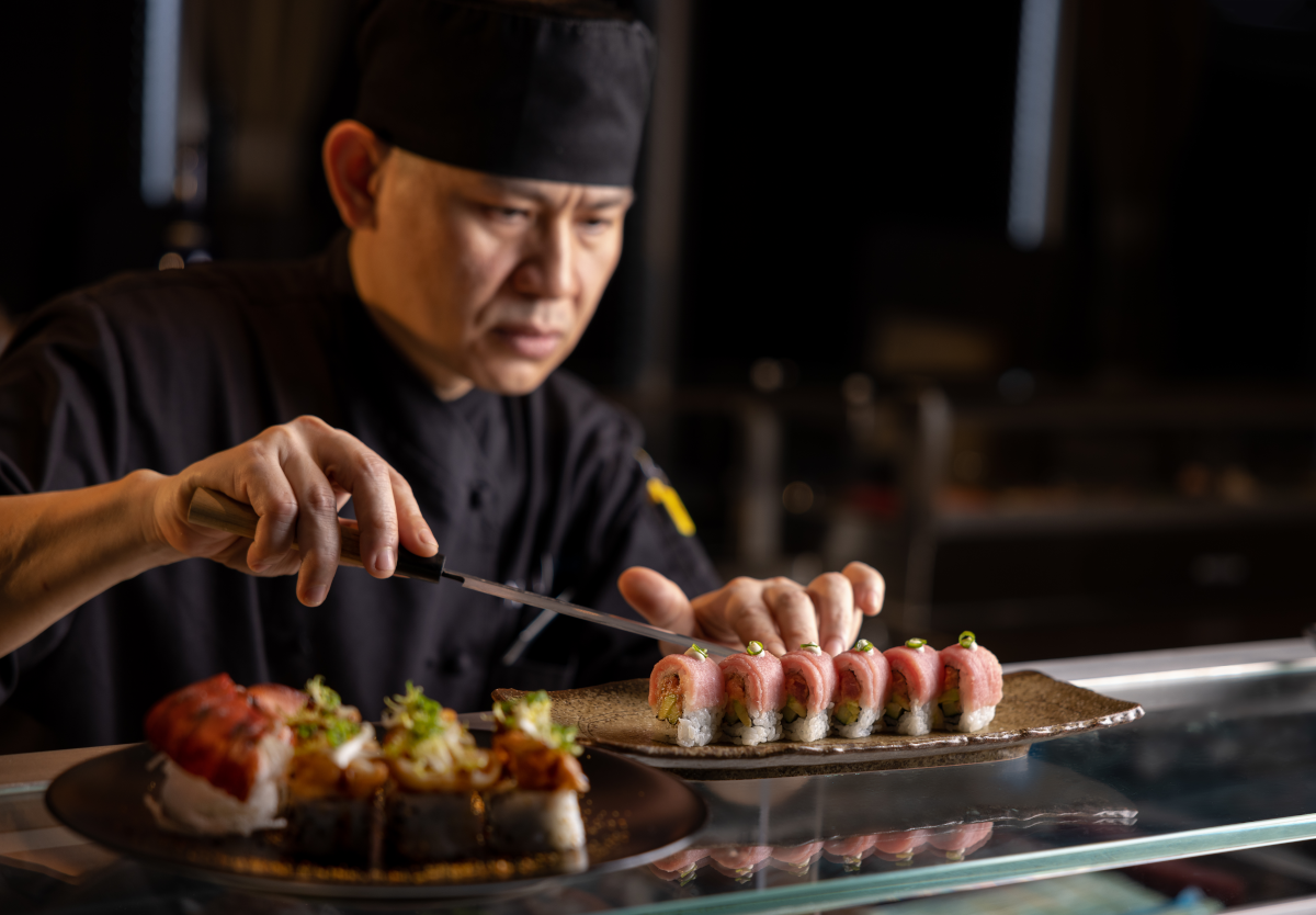 A Nami Sushi chef preparing a plate of sushi aboard a Holland America Line ship