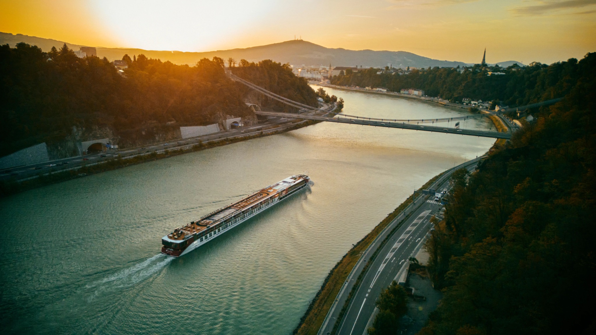 AmaSofia sailing along a European river beneath the warm light of sunset