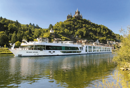 A Scenic river ship sailing beneath a hilltop castle